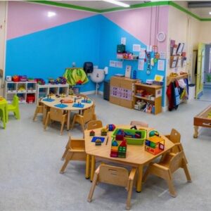 Bright classroom with colorful toys and furniture.